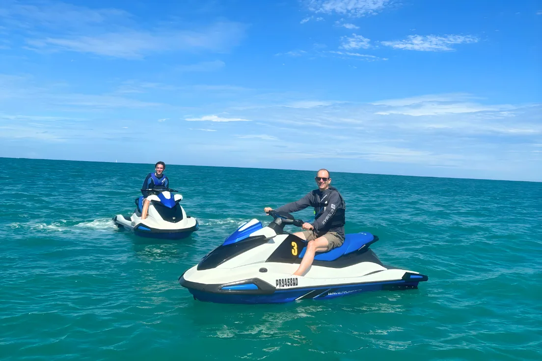 Jet ski riders stopped on open water for photos near Pine Grove Beach, Puerto Rico