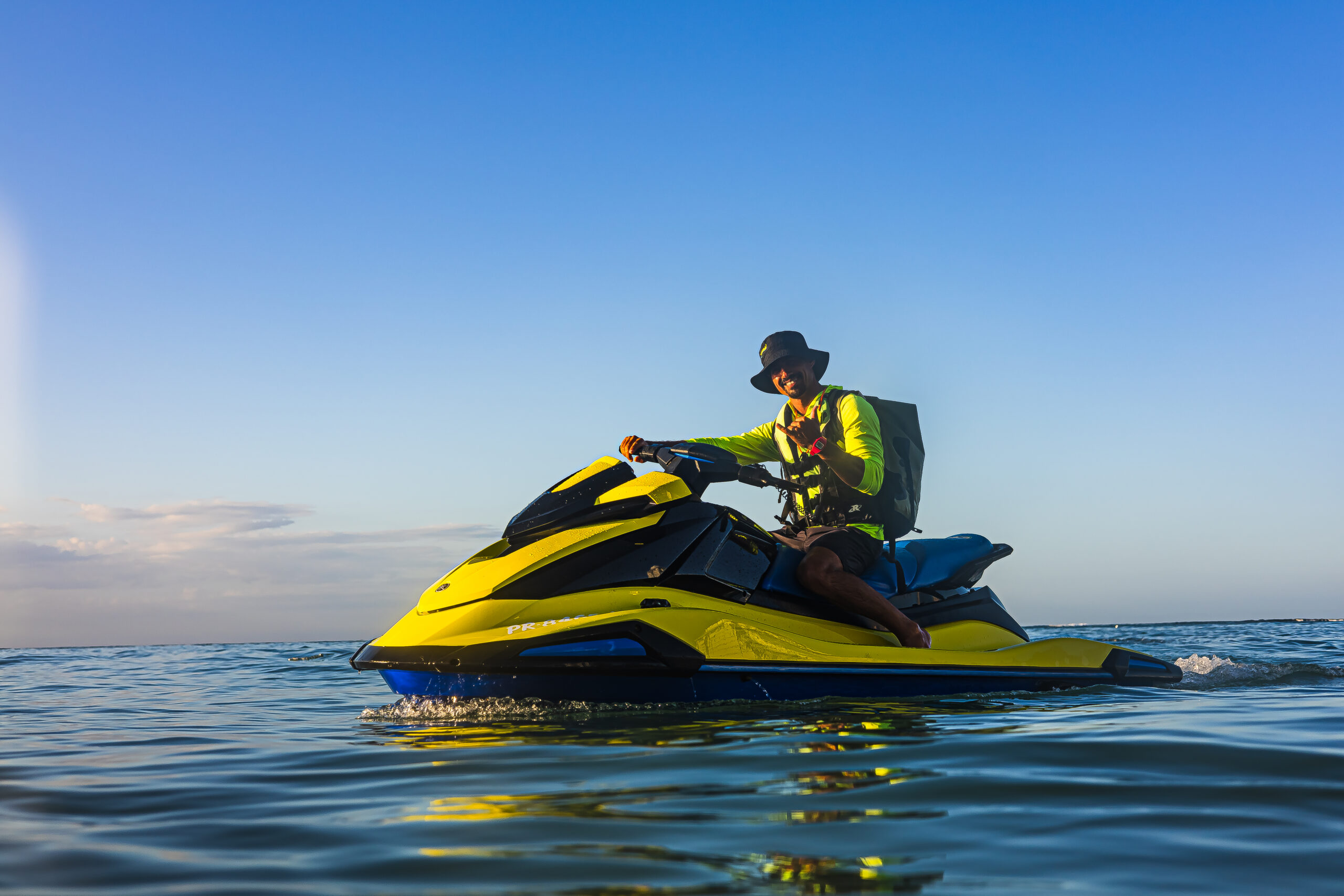 Rider on a yellow Yamaha VX jet ski on calm water in Puerto Rico