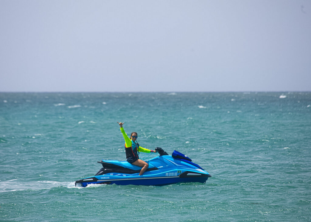 Blue WOW jet ski cruising on open turquoise water